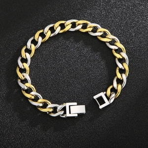 Two-tone gold and silver Cuban link bracelet with fold-over clasp on black stones