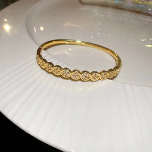 Macro shot of gold plated snake-shaped cuff bracelet with sparkling zircon pavé inlays