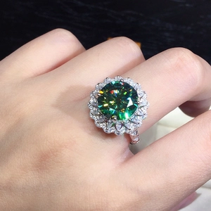 Macro view of green zircon ring featuring a double petal halo and micro-pave diamond band