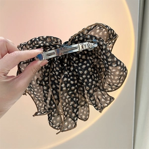 Detail of metal spring clip on leopard print chiffon bow with Clip France engraving