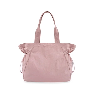 Detail view of mauve yoga tote bag featuring side drawstrings and premium waterproof fabric