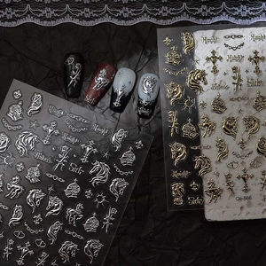 Close-up of gold and silver gothic knight nail stickers with cross and crown patterns