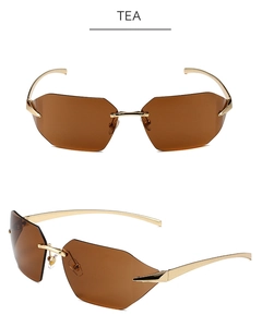 Detail view of tea-tinted rimless sunglasses with gold metal temples and curved lenses