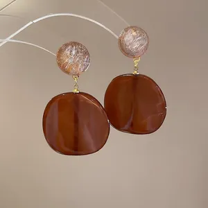 Brown resin drop earrings with silver needle and gold-flecked spherical accents