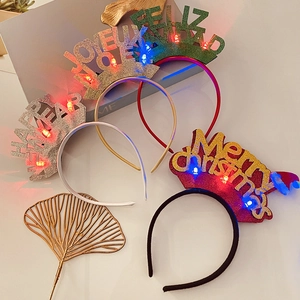 Detail of four colorful festive LED headbands with glittering Merry Christmas holiday slogans