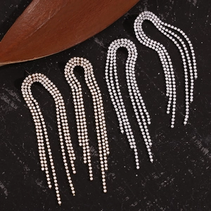 Close-up of 18K gold and silver plated tassel earrings with micro-set zircon rows