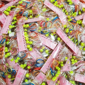 Detailed view of bulk tennis racket and ball keychains in multiple vibrant colors