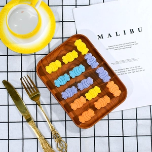 Colorful swirl candy silicone molds in yellow blue purple orange on a wooden tray