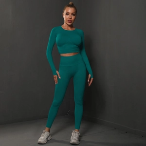 Detail of teal seamless yoga set showing thumb holes and high waist compression fabric