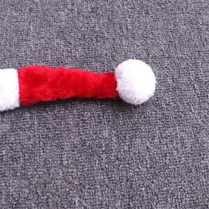 Detailed view of the soft red plush fabric and white pompom on a long Christmas hat