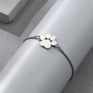 Detailed macro of the silver stainless steel claw paw charm on the adjustable keel chain