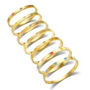 Set of seven gold stainless steel bangles with colorful enamel floral heart patterns