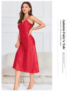 Detail of red satin slip dress showing the V-neckline and silky gloss of the fabric
