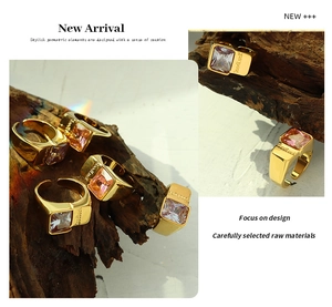 Detailed macro view of a gold-plated ring with a large pink rectangular crystal gemstone