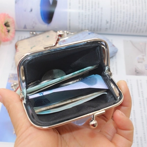 Close-up of vintage canvas coin purse with metal kiss lock showing interior storage space