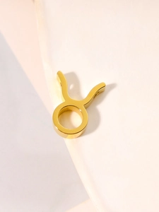 Close-up of a gold Taurus zodiac pendant made of polished stainless steel for DIY jewelry