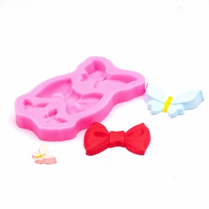 Moule en silicone rose avec motifs papillons et nœuds pour décoration de gâteau fondant