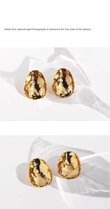 Detail view of gold irregular hammered texture oval earrings with metallic finish
