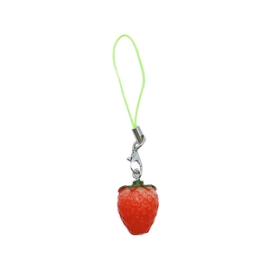 Handmade strawberry phone charm with red resin fruit and green leaf on white background