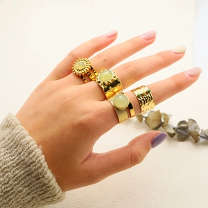 Bohemian gold ring set with natural green stones featuring sunburst and hammered textures