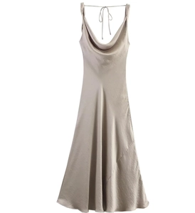 Close-up detail of champagne satin slip dress featuring elegant cowl neck and silky texture