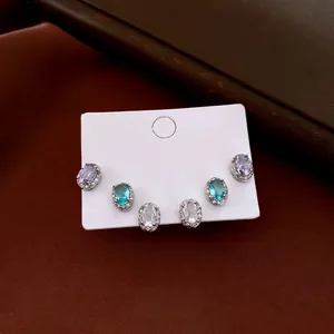 Three-pair set of oval zircon stud earrings in purple, blue, and white with silver pins