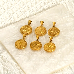 Vintage gold coin pendant necklaces with 12 lucky flower reliefs on marble tray