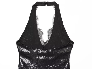 Detail of black sequin halter dress featuring intricate lace trim and glossy texture