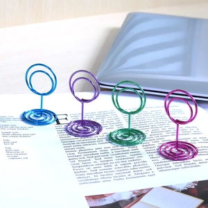Colorful spiral metal place card holders in blue, purple, green and rose red
