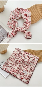 Detail of square cotton linen scarf with red floral print and scalloped embroidered edges