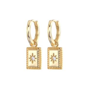 Detailed macro of S925 sterling silver gold earrings with starburst and zircon charms