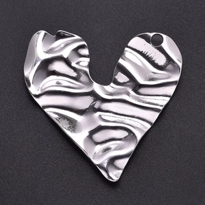 Detailed macro view of heart pendant with irregular wrinkled texture in 304 stainless steel