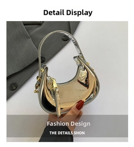 Detail of silver and gold gradient crescent mini bag with metallic finish and gold hardware