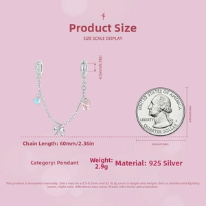 Macro view of 925 silver charm with bow and heart pendants beside a scale coin