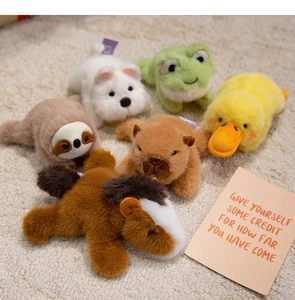 Collection of plush animal magnets including sloth and capybara on beige carpet