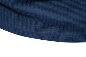 Close-up of deep blue waffle knit fabric texture on men's long sleeve T-shirt hem