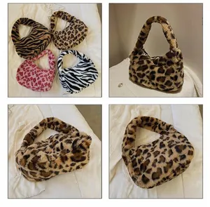 Detail of plush faux fur shoulder bags with diverse animal prints and zipper closure