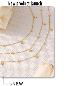 Macro detail of gold star charms on a titanium steel necklace with elegant polishing