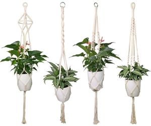 Set of 4 bohemian cotton rope plant hangers with wooden beads on white background