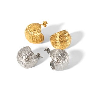 C-shaped hammered titanium steel earrings in gold and silver with textured finish