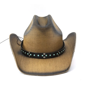 Detail of woven straw cowboy hat with turquoise beads and silver stud decorative band