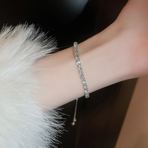 Macro shot of adjustable silver tennis bracelet with cubic zirconia and a sliding clasp