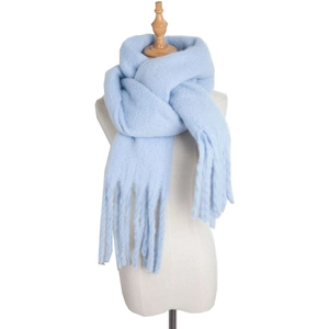 Thick light blue mohair knit scarf with tassels on mannequin for winter warmth