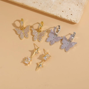 Star and butterfly zircon drop earrings in 14K gold and silver finish on stone base
