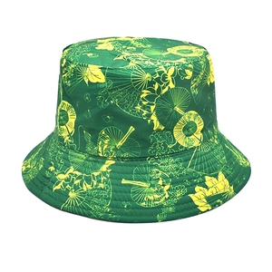 Close-up of deep green bucket hat with yellow floral patterns and reinforced stitching