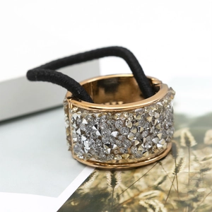Golden ponytail holder with sparkling round rhinestones and black elastic band