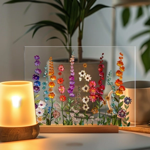 Floral acrylic table decor with colorful dried flowers and warm wooden base stand