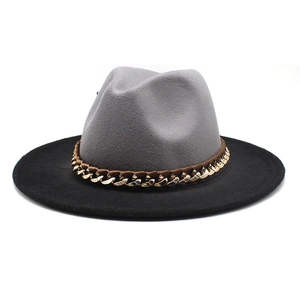 Close-up of wool fedora with gradient grey crown, black brim, and gold chain detail