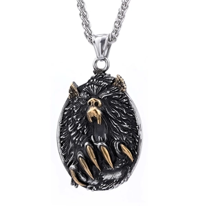 Detailed close-up of a punk-style bear claw pendant in dual-tone black and gold stainless steel