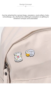 Detail of science enamel pins with atom and flask designs pinned to a white canvas bag